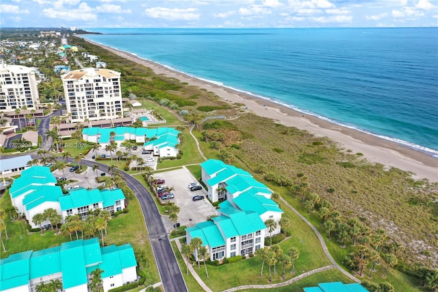 aerial view with a water view and a view of the beach