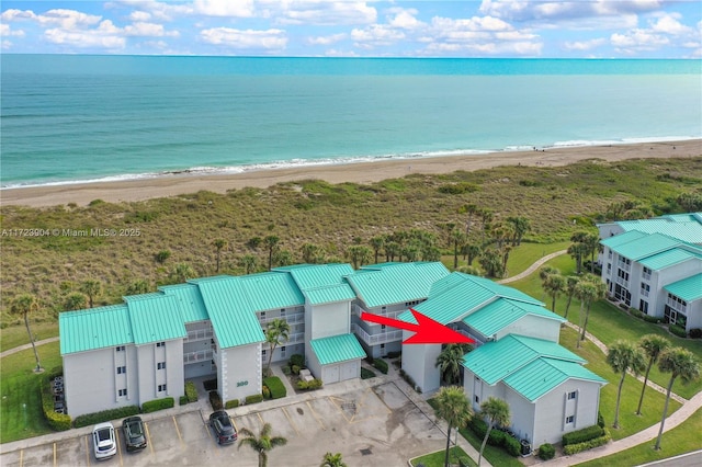 drone / aerial view with a beach view and a water view