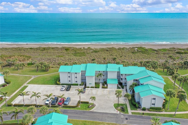 aerial view with a water view and a beach view