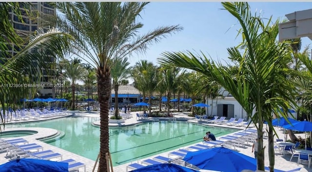 community pool featuring a patio and a hot tub