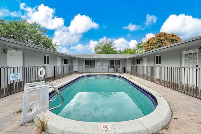 view of swimming pool featuring a patio area