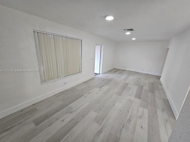 spare room with light hardwood / wood-style flooring