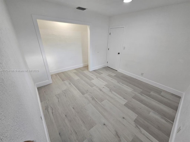 spare room featuring light hardwood / wood-style flooring