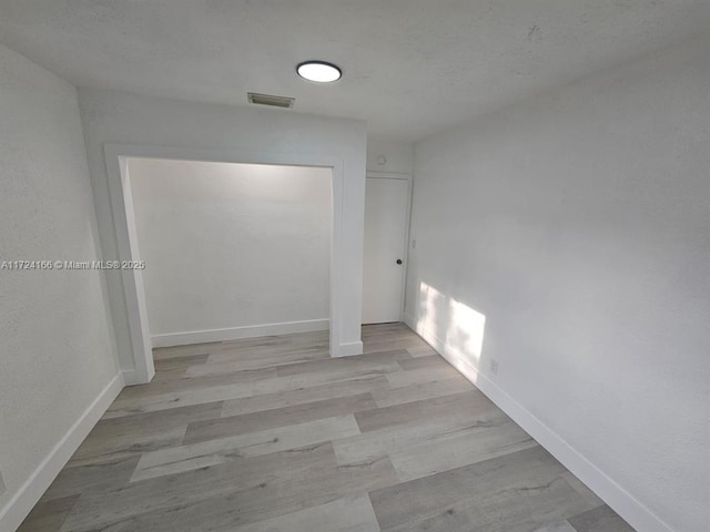 corridor with light hardwood / wood-style floors