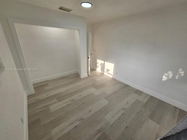 unfurnished room with light hardwood / wood-style flooring