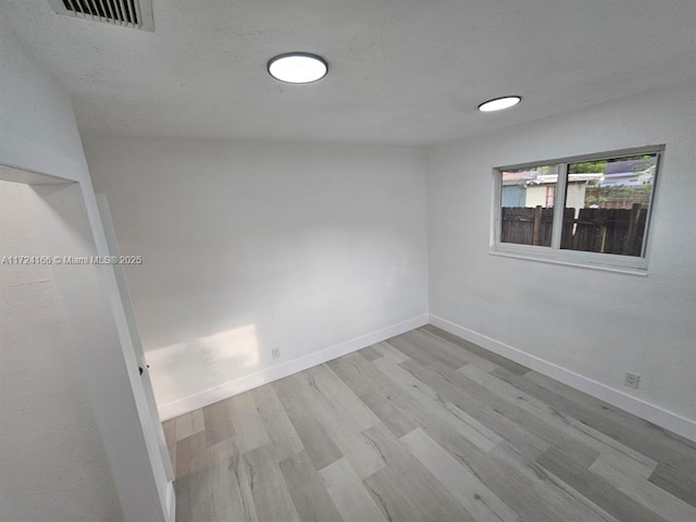 unfurnished room with light wood-type flooring