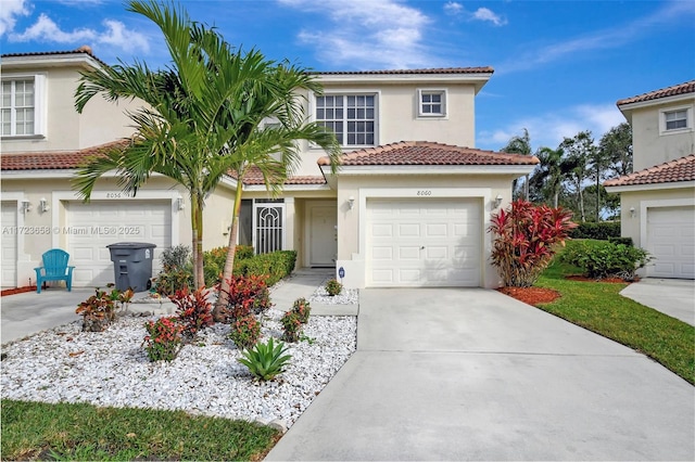 mediterranean / spanish-style home with a garage