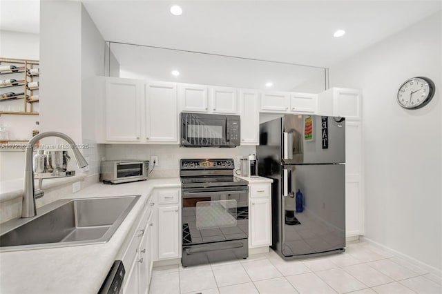 kitchen with light tile patterned floors, sink, white cabinets, and black appliances