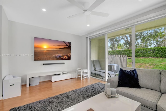 living room with ceiling fan and hardwood / wood-style floors