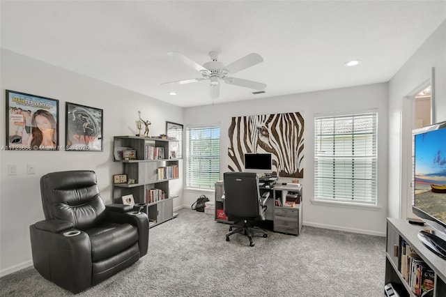 carpeted office featuring ceiling fan and plenty of natural light