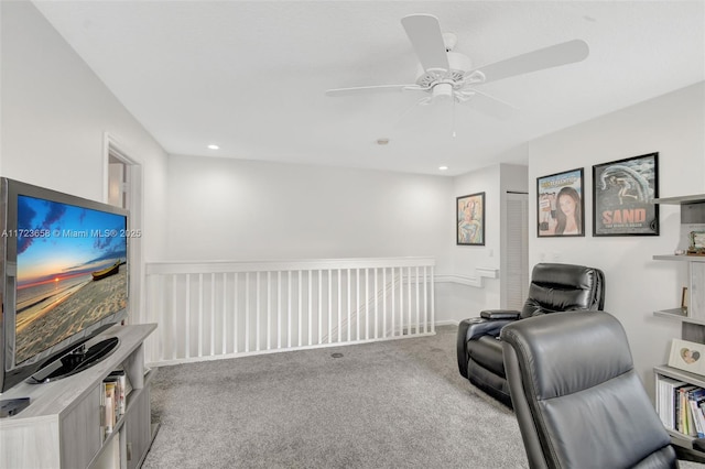 sitting room featuring ceiling fan and light carpet