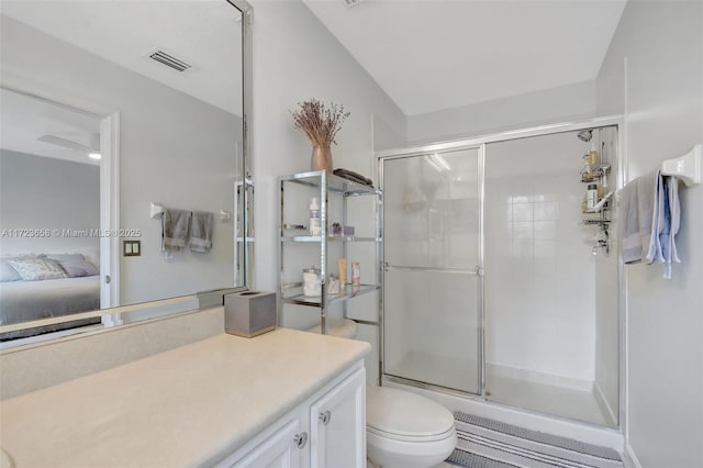 bathroom with toilet, a shower with shower door, and vanity