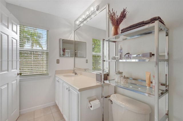 bathroom featuring toilet, vanity, and tile patterned flooring