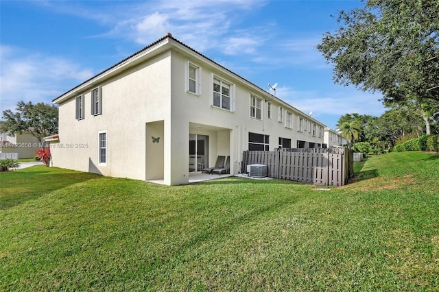 back of property featuring a lawn and a patio area