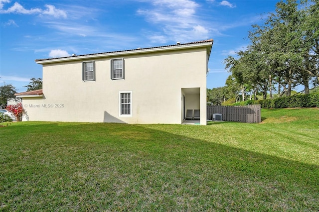 rear view of house featuring a yard