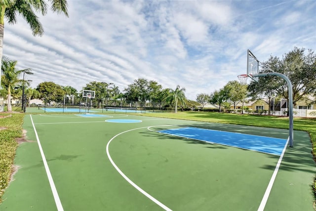 view of sport court with a lawn and tennis court