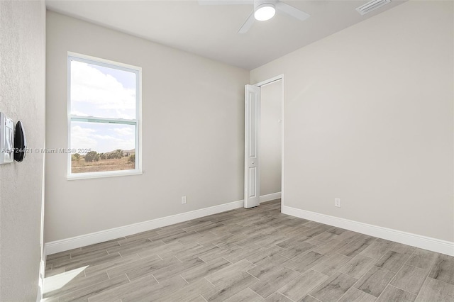 empty room featuring light wood-type flooring and ceiling fan