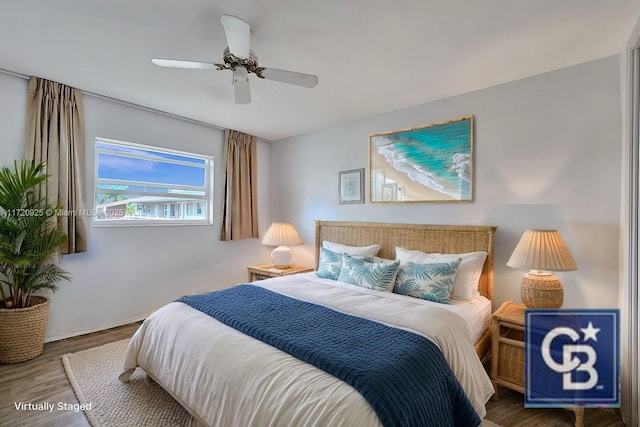 bedroom with ceiling fan and wood-type flooring