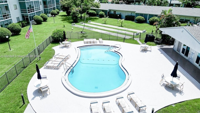 view of swimming pool with a lawn and a patio