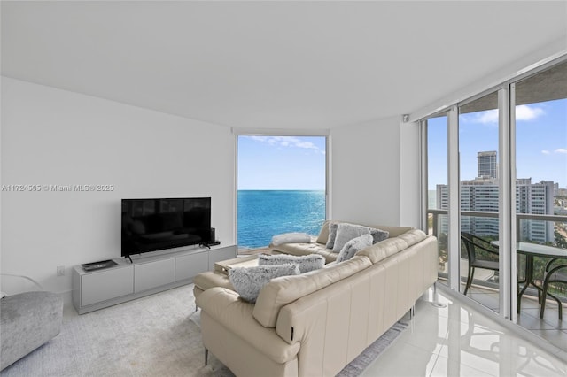 living room with a wall of windows and light tile patterned floors