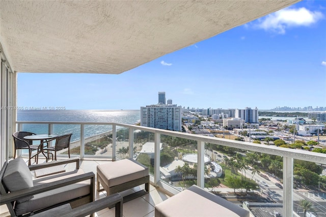 balcony featuring a city view and a water view