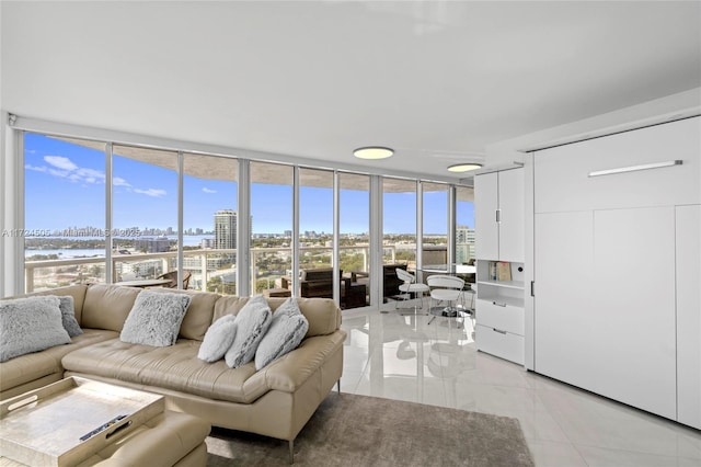 living room with floor to ceiling windows and light tile patterned floors