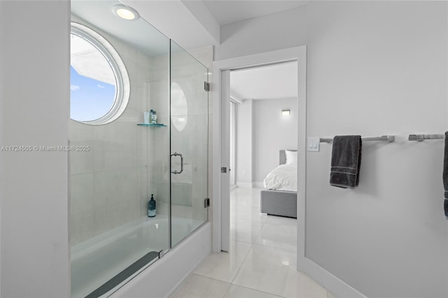 bathroom featuring enclosed tub / shower combo and tile patterned floors