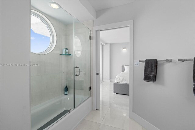 full bathroom featuring connected bathroom, baseboards, bath / shower combo with glass door, and tile patterned floors