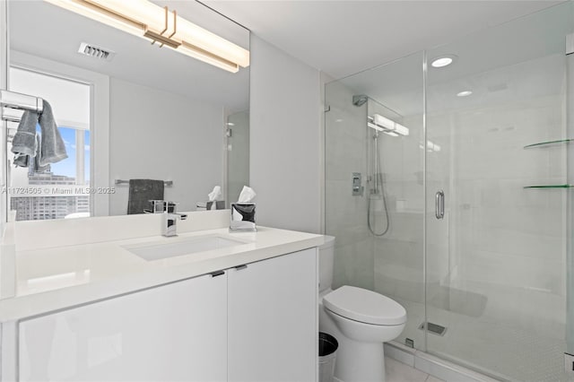 full bathroom with a stall shower, vanity, toilet, visible vents, and recessed lighting