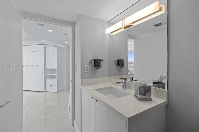bathroom featuring recessed lighting, visible vents, and vanity