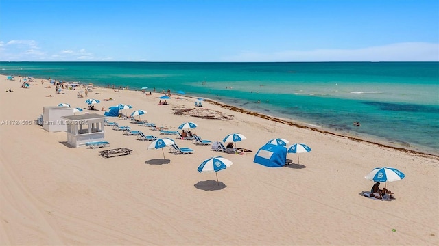 aerial view featuring a view of the beach and a water view