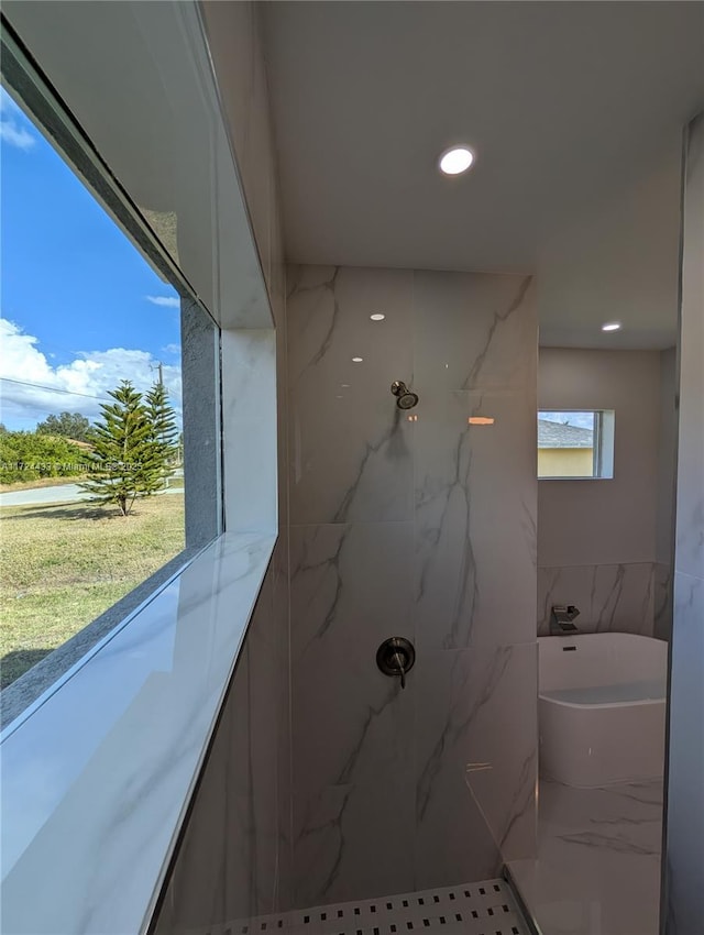 bathroom with tile walls and tiled shower