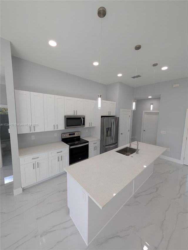 kitchen with white cabinetry, hanging light fixtures, and stainless steel appliances