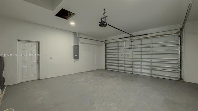 garage with a garage door opener and electric panel