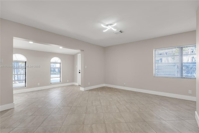 unfurnished room with light tile patterned floors