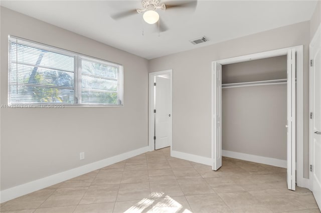 unfurnished bedroom featuring ceiling fan, a closet, and light tile patterned floors