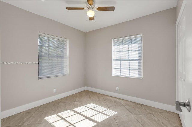 tiled empty room featuring ceiling fan and a healthy amount of sunlight