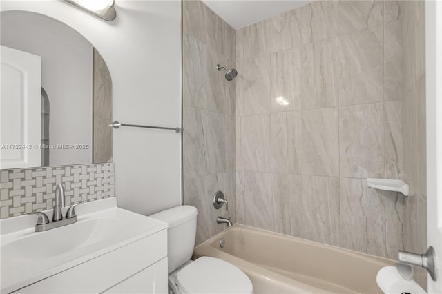 full bathroom featuring decorative backsplash, toilet, vanity, and tiled shower / bath