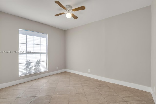 empty room featuring light tile patterned floors, ceiling fan, and a healthy amount of sunlight