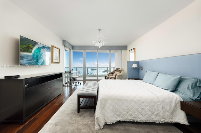 bedroom featuring dark hardwood / wood-style flooring, a wall of windows, and a notable chandelier