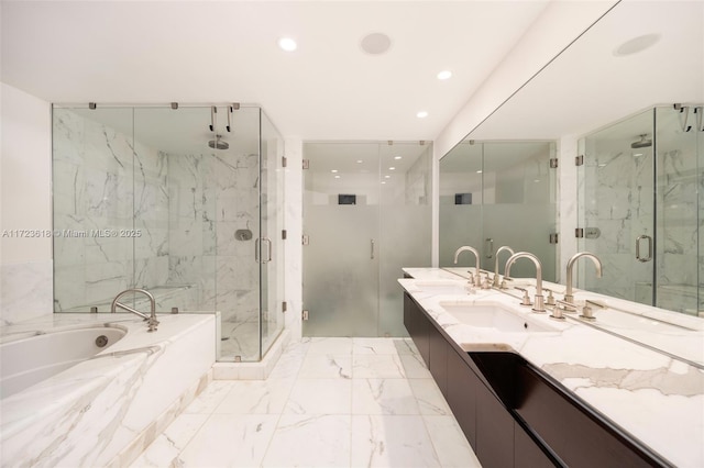 bathroom featuring vanity and separate shower and tub