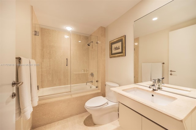 full bathroom featuring vanity, tiled shower / bath combo, tile patterned floors, and toilet