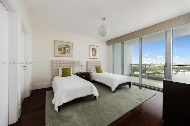 bedroom featuring access to exterior and dark hardwood / wood-style flooring