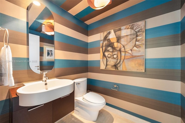 bathroom featuring tile patterned flooring, toilet, and sink