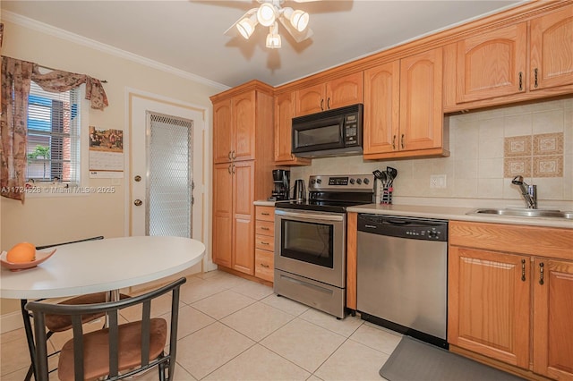 kitchen featuring sink, ornamental molding, tasteful backsplash, light tile patterned flooring, and stainless steel appliances