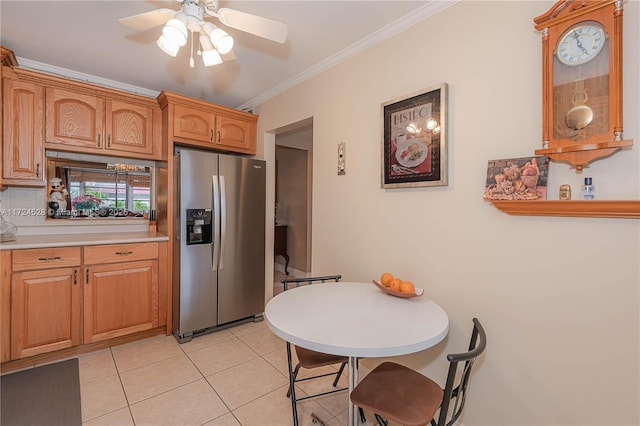 kitchen with stainless steel fridge, light tile patterned floors, ceiling fan, and crown molding