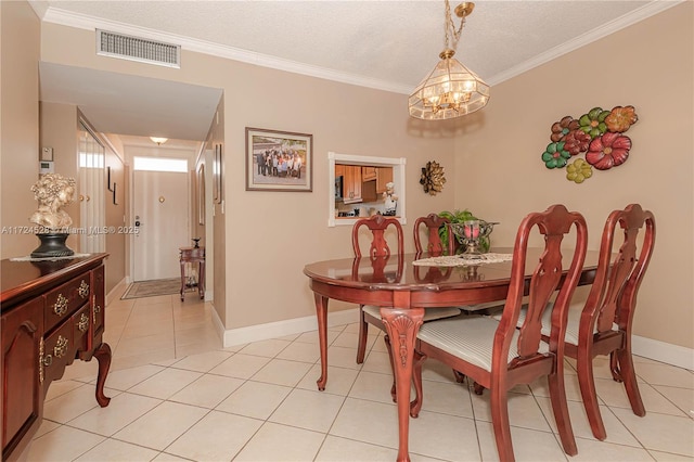 dining room with light tile patterned floors, a textured ceiling, an inviting chandelier, and ornamental molding