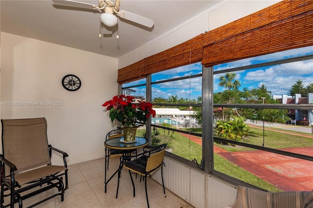 sunroom featuring ceiling fan