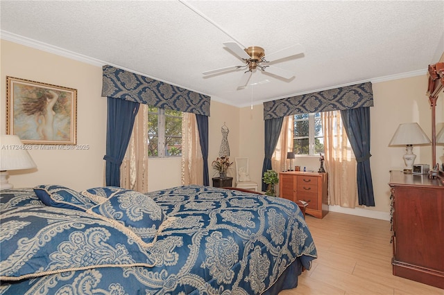 bedroom featuring multiple windows, a textured ceiling, and ceiling fan