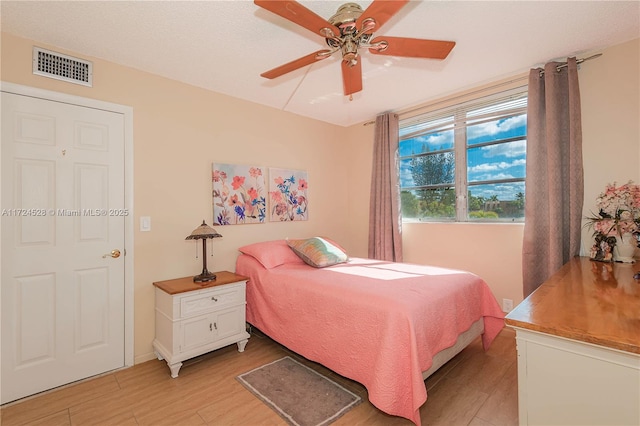 bedroom with ceiling fan and light hardwood / wood-style flooring